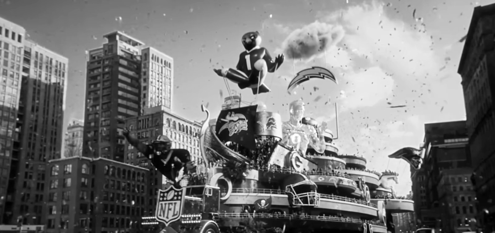 Still from the NFL “Ride the Float” spot: a giant team-themed parade float rolling down a city street in confetti