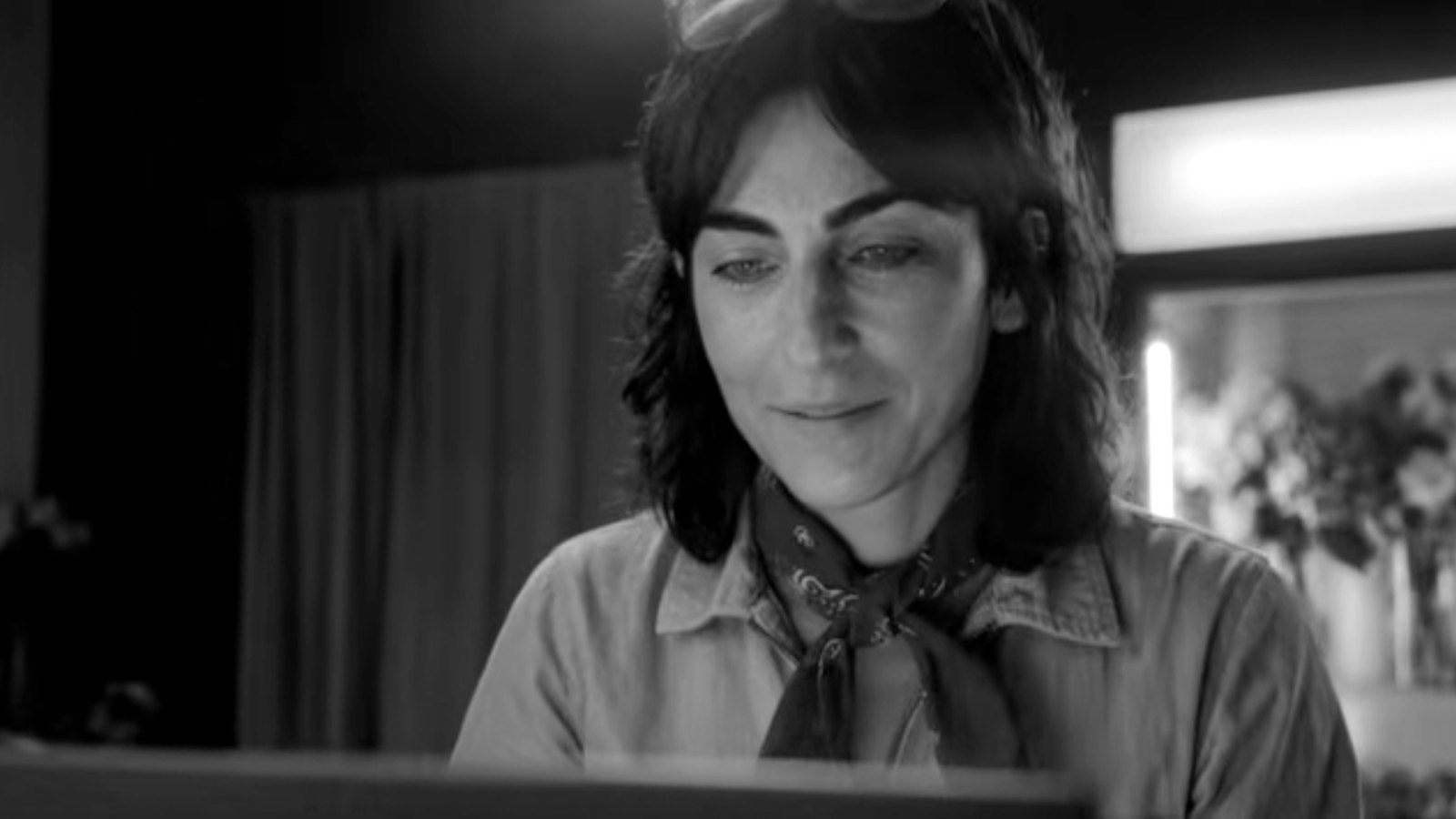 Still from Xero “Love Changes Everything”: a small-business owner smiling at her laptop